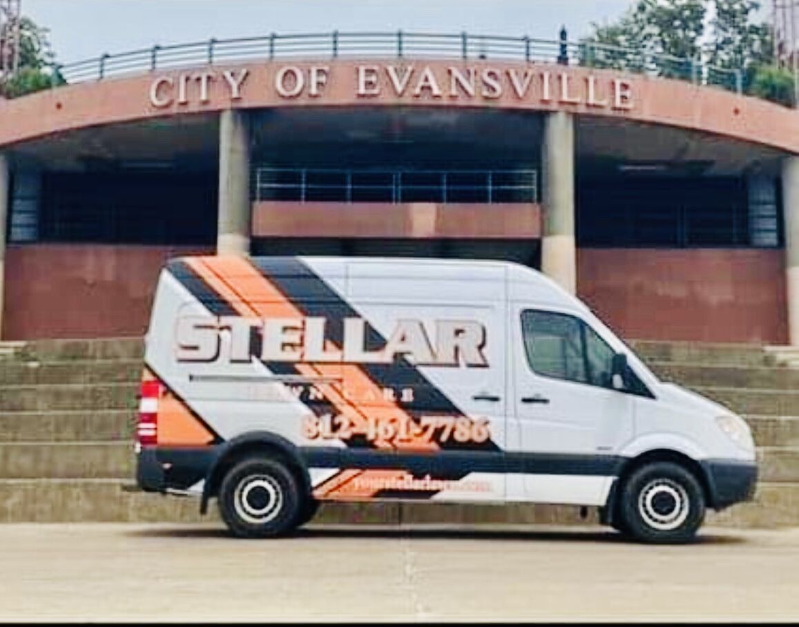 Stellar Lawn Care Van in front of Evansville sign